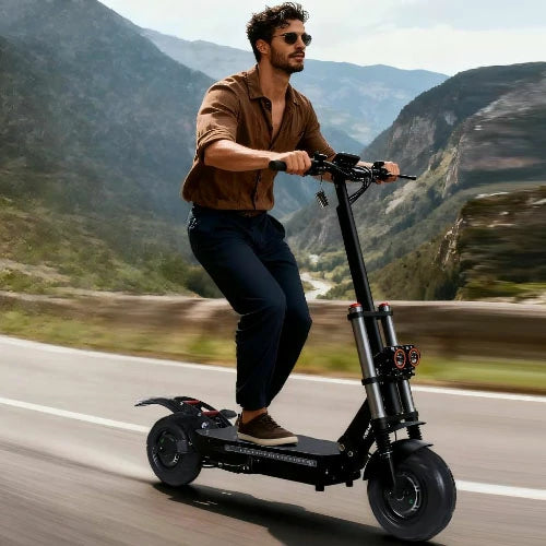 FREEBOY rugged electric scooter rider traveling on mountain roadside